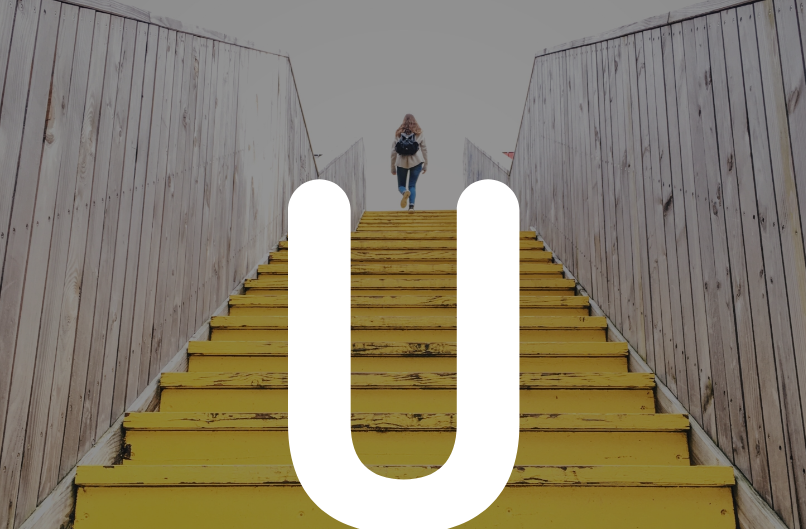 Woman walking up stairs with an overlay U